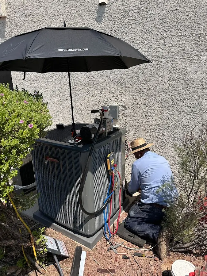 HVAC technician performing outdoor AC maintenance in Bryn Mawr-Skyway