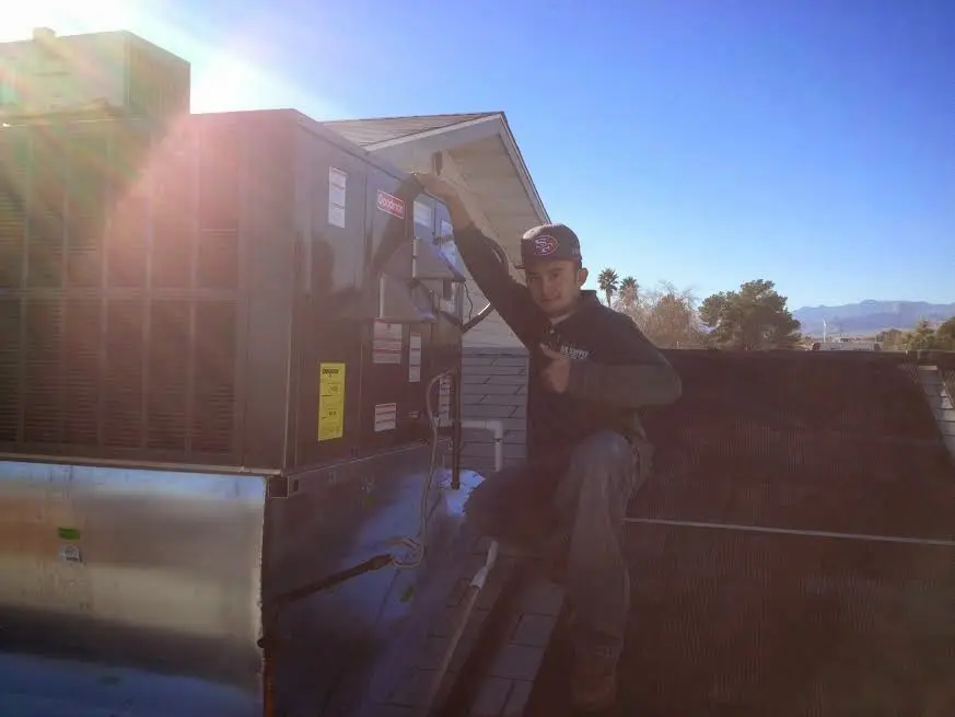 HVAC technician performing Air Duct Repair on a rooftop unit in Bryn Mawr-Skyway